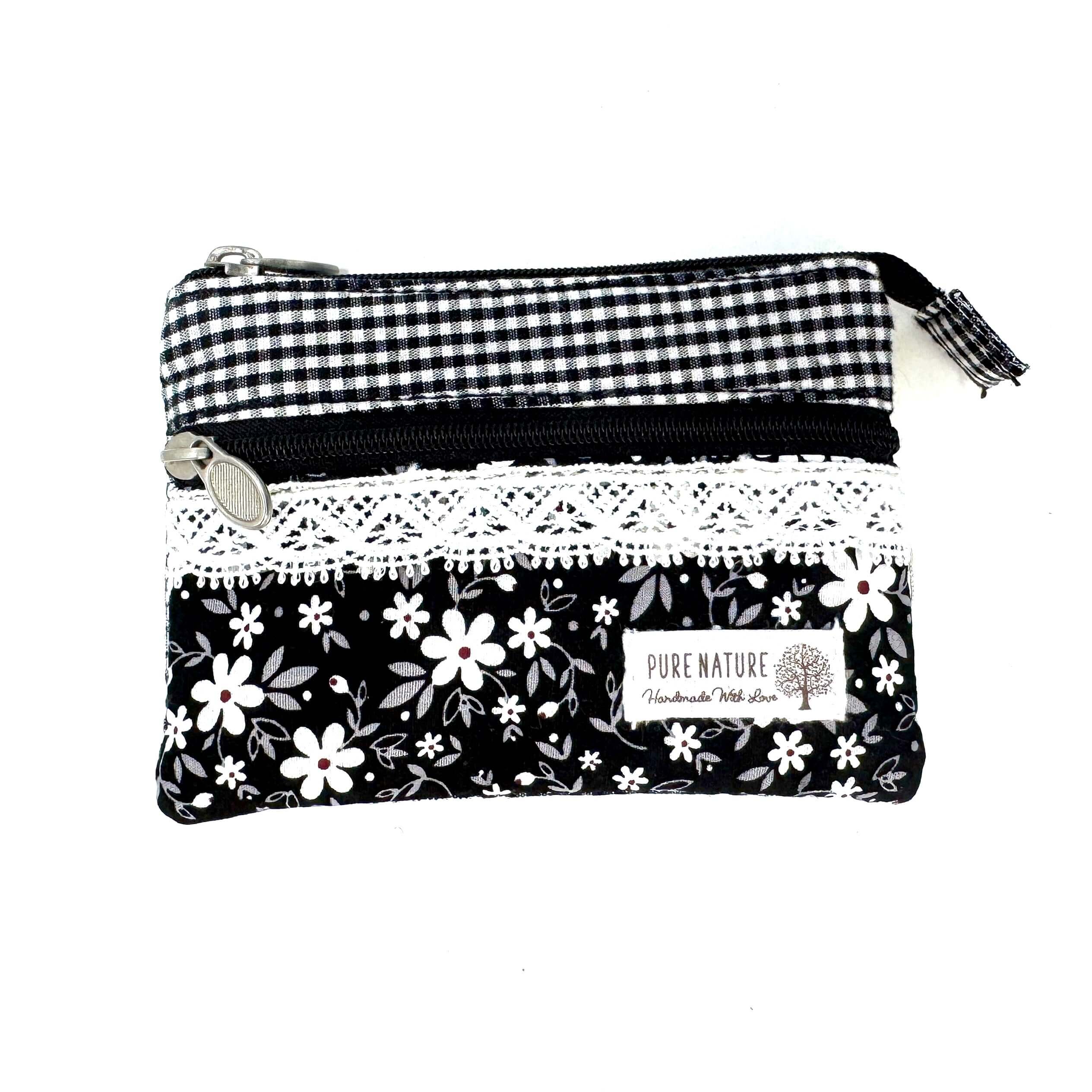 Schwarzes Canvas-Täschchen mit buntem Blumenmuster und weißen Punkten, kleine Kosmetiktasche aus robustem Stoff mit Reißverschluss, kompakte Größe für unterwegs