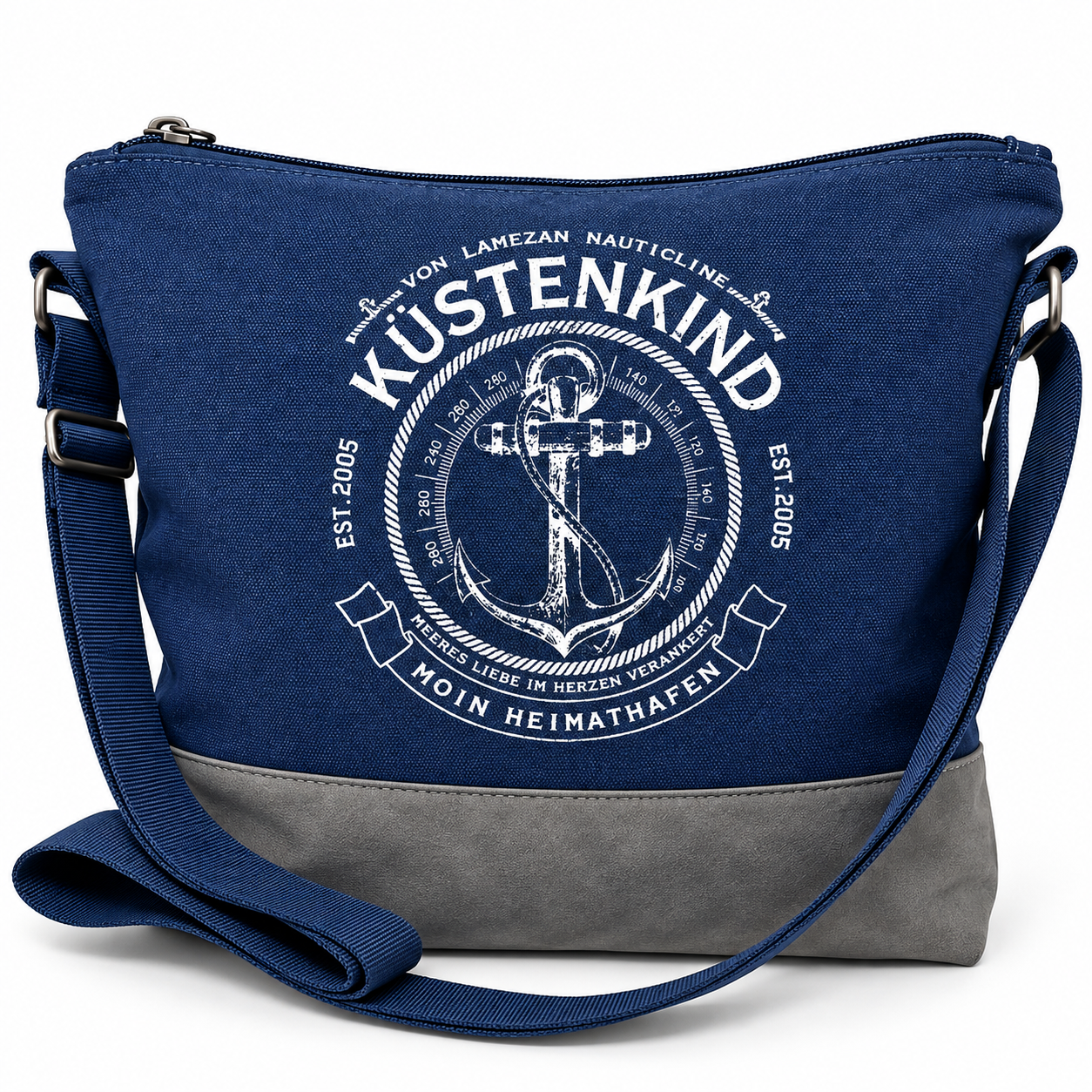 Marineblaue maritime Umhängetasche Küstenkind mit weißem Anker- und Kompassmotiv, Schriftzug „Moin Heimathafen“, grauem Taschenboden und verstellbarem Schultergurt.