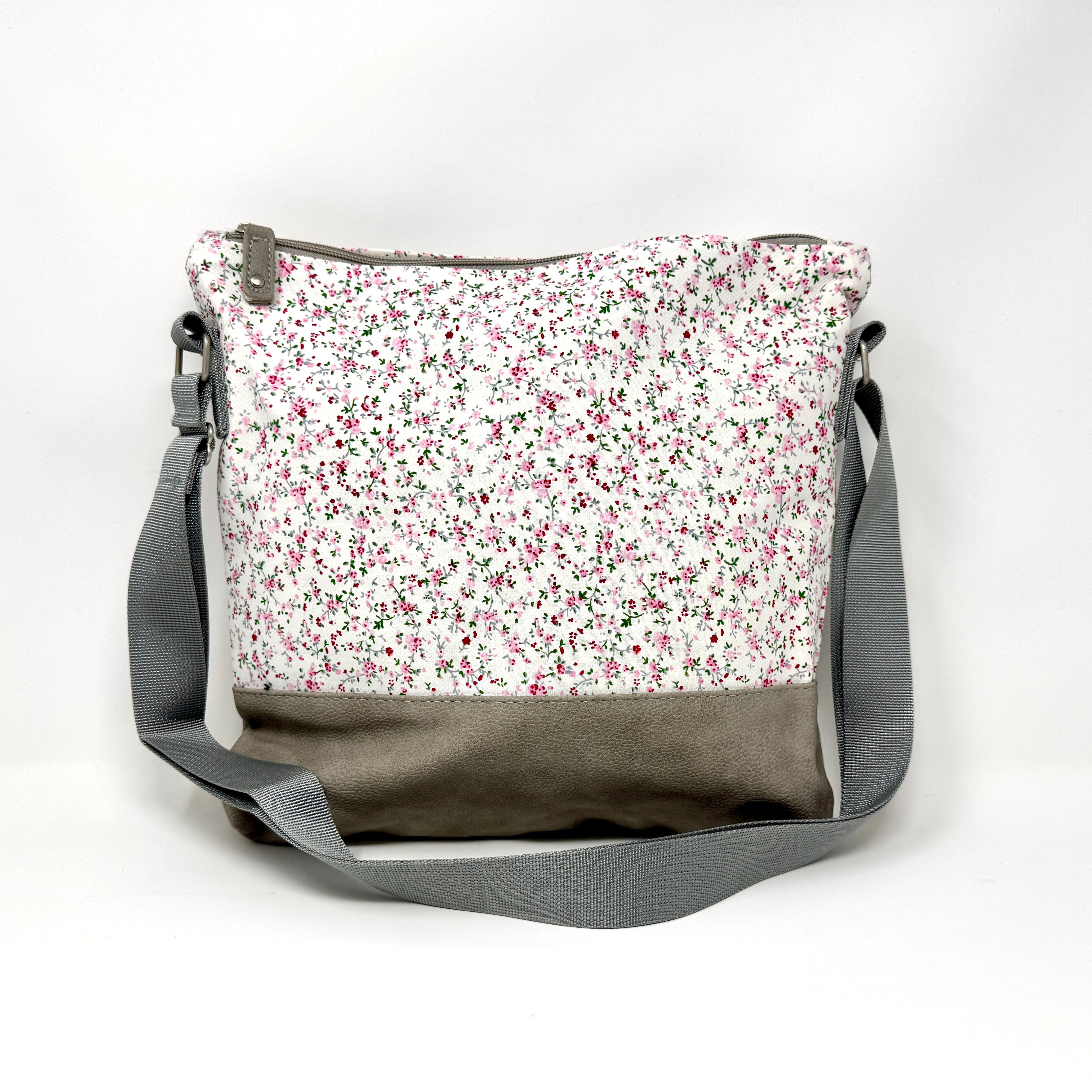 Graue Umhängetasche aus Stoff mit floralem Blumenmuster und verstellbarem Schultergurt